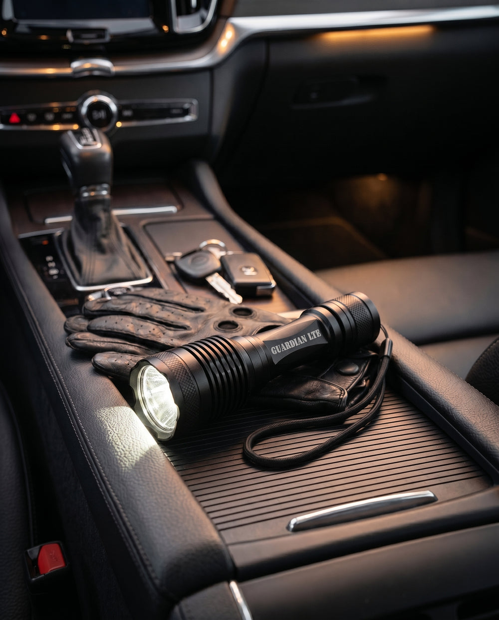 Guardian LTE on a vehicle console beside gloves and keys